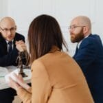 Professional discussion among lawyers in a modern office, focusing on legal matters.