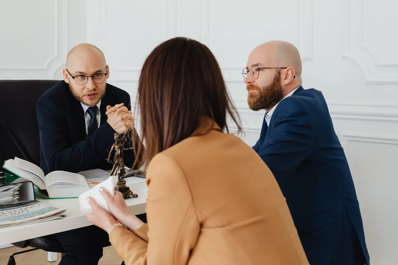 Professional discussion among lawyers in a modern office, focusing on legal matters.